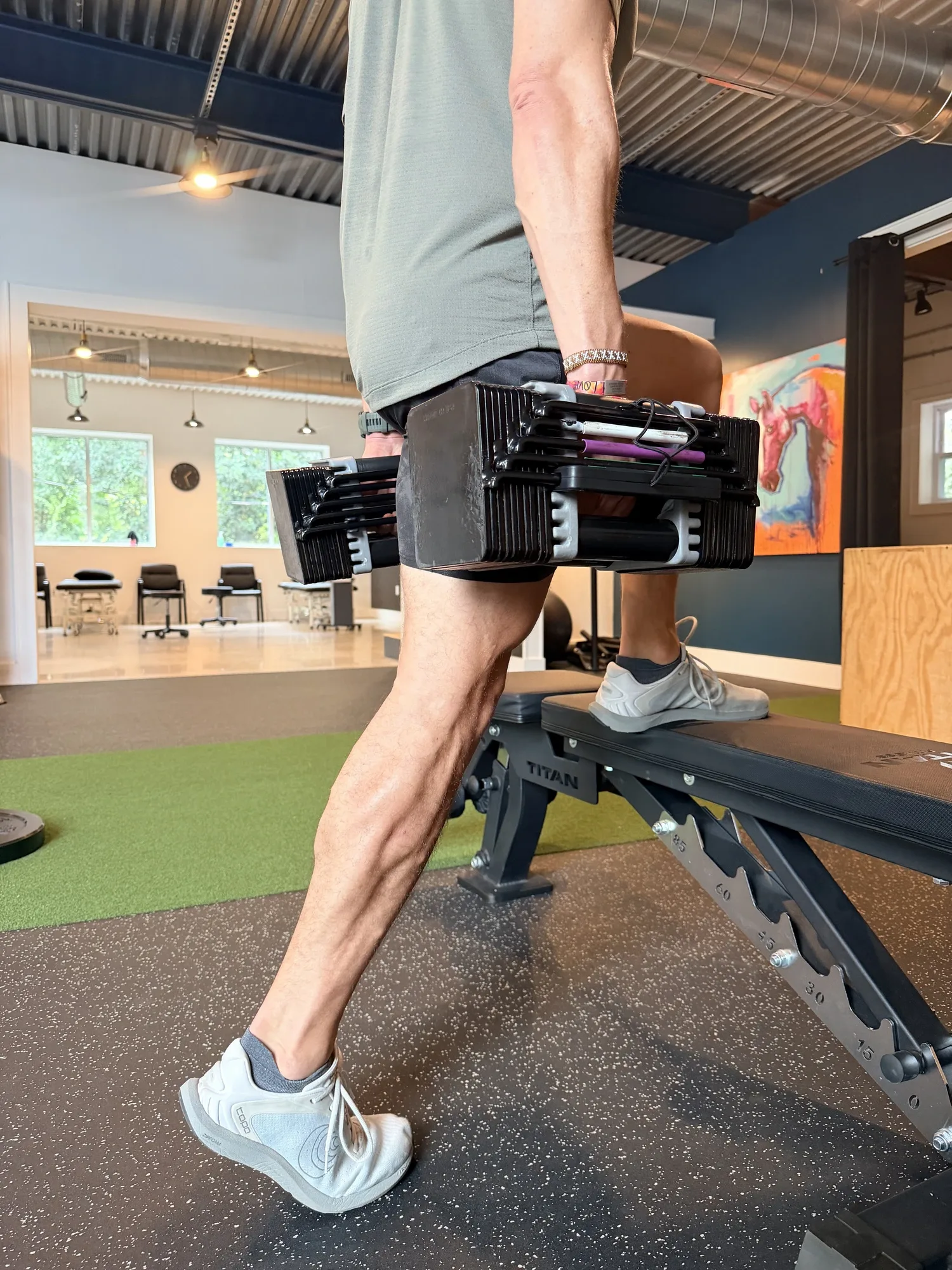Straight-knee single-leg dumbbell calf raise demonstrated by a Doctor of Physical Therapy, training both the gastrocnemius and soleus, at Swamp Rabbit Physiotherapy in Greenville, SC